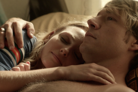 Elena lies beside Jamie in Hulu's Little Fires Everywhere.