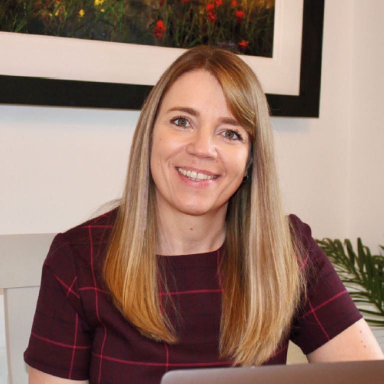 Woman smiling a screen