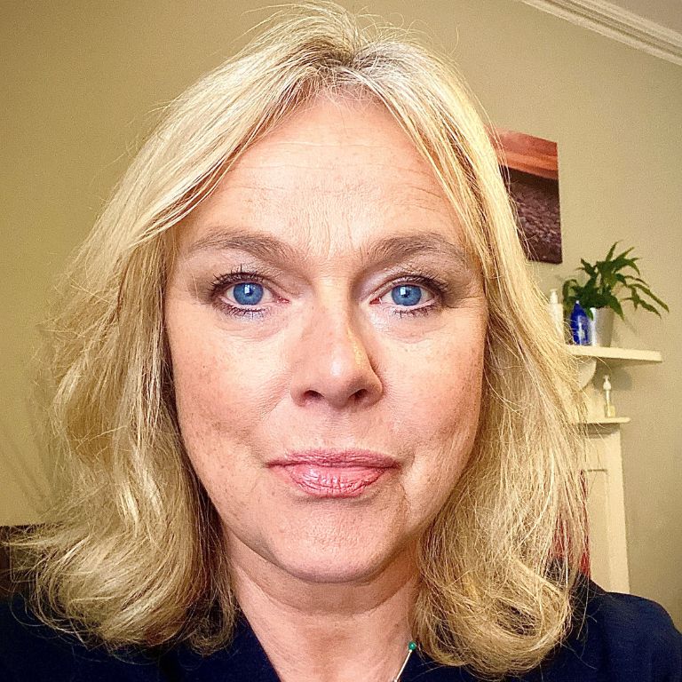 Woman smiling a screen