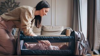 Woman changing her baby in the Bizzi Growin POD