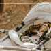 Why do babies need to lie flat in a pram?