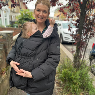 Our editor and tester, Anna Bailey, wearing the Seraphone maternity and babywearing puffer coat
