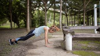 Woman doing burpee in park