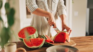 woman cutting watermelon