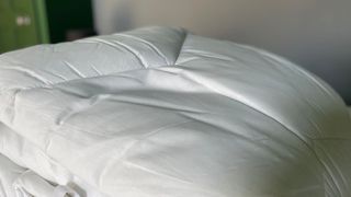 The White Company Hypoallergenic Topper rolled up