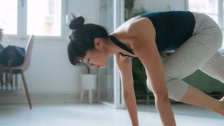 Woman doing mountain climber exercise at home