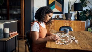 woman doing jigsaw puzzle