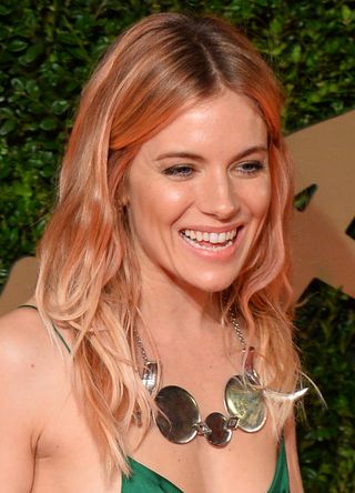 Sienna Miller poses on the red carpet as she arrives for the British Fashion Awards in London on December 2, 2013