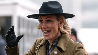 Zara Tindall greets a friend as she arrives at Cheltenham Racecourse on March 13, 2025