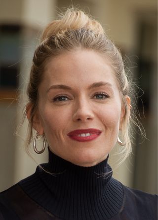 Sienna Miller poses for the photographers after she unveiled her cabin sign as a tribute for her career along the Promenade des Planches during the 45th Deauville American Film Festival on September 11, 2019 in Deauville, France