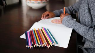 woman using colouring book