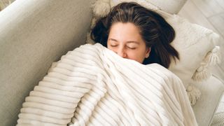 woman under heated blanket