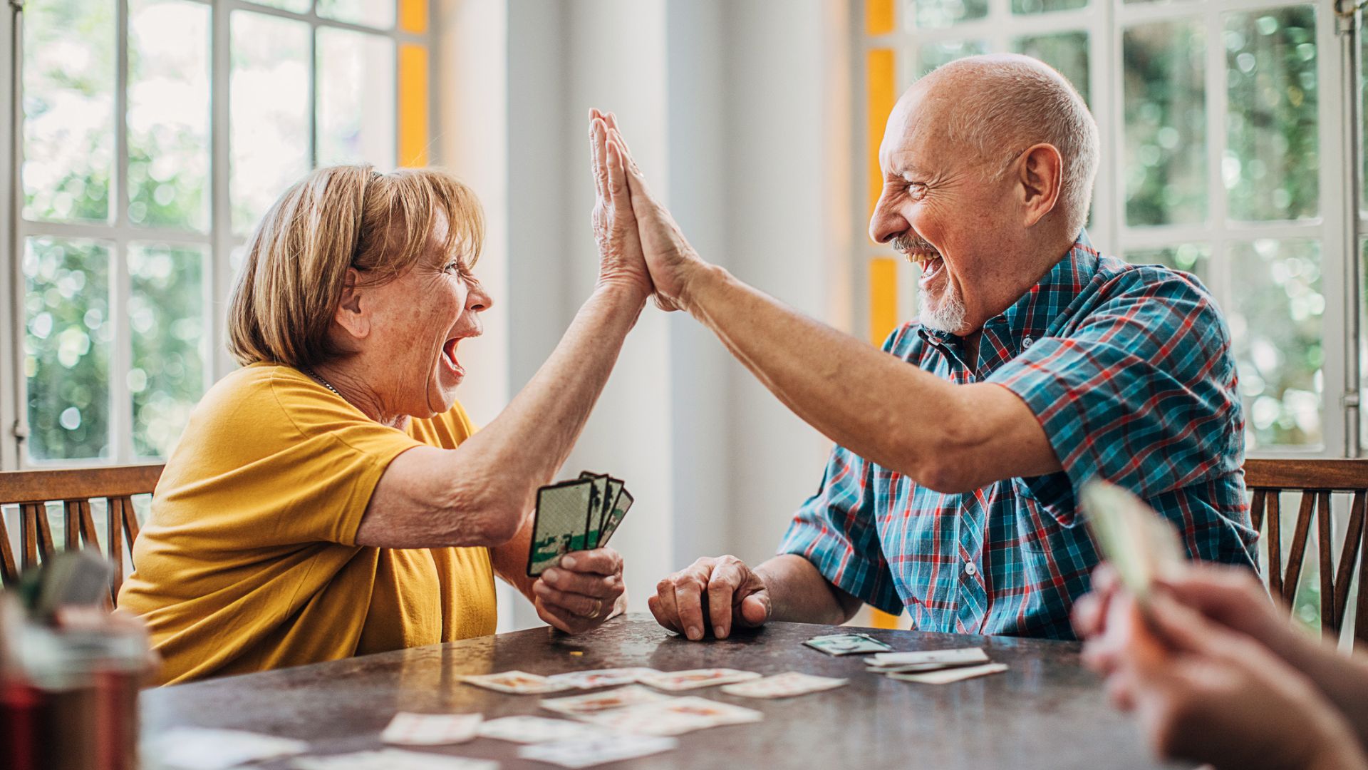 A couple high five playing cards