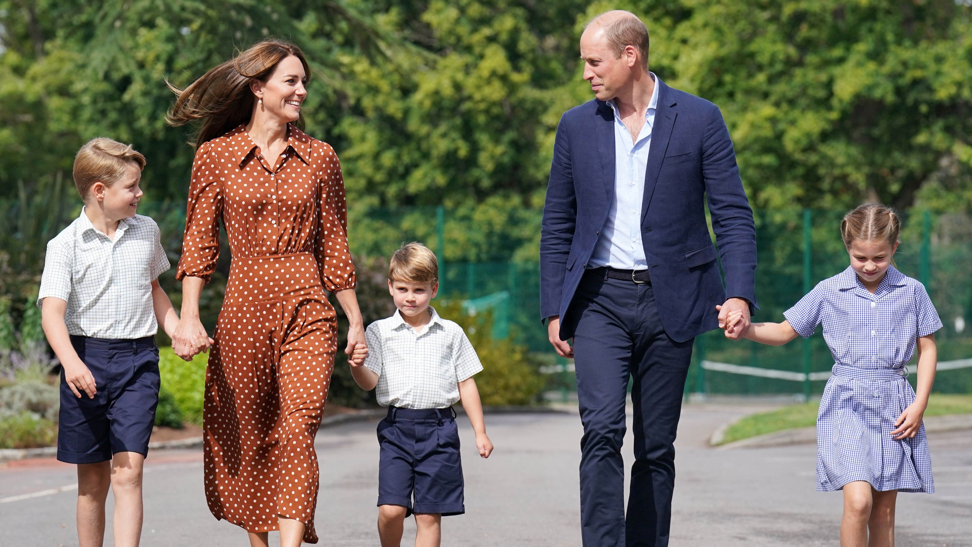The Wales family walk hand in hand as the children arrive for a settling-in afternoon at Lambrook School