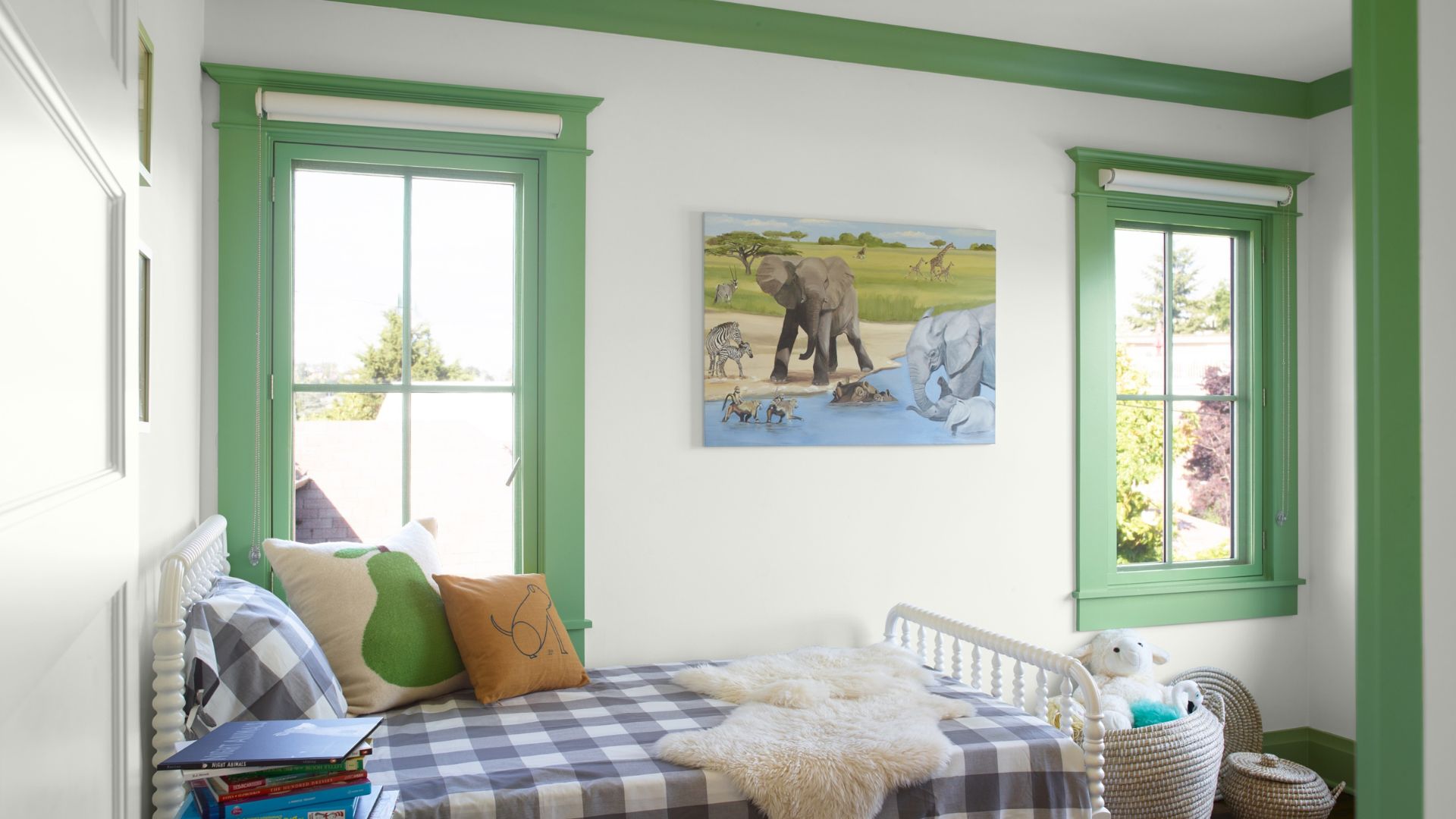 A child's bedroom with white walls and the woodwork painted in pistachio green