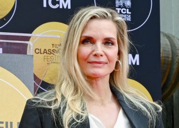 Michelle Pfeiffer’s sapphire blue swimsuit and crystal-encrusted shades take poolside glamour to a whole new level