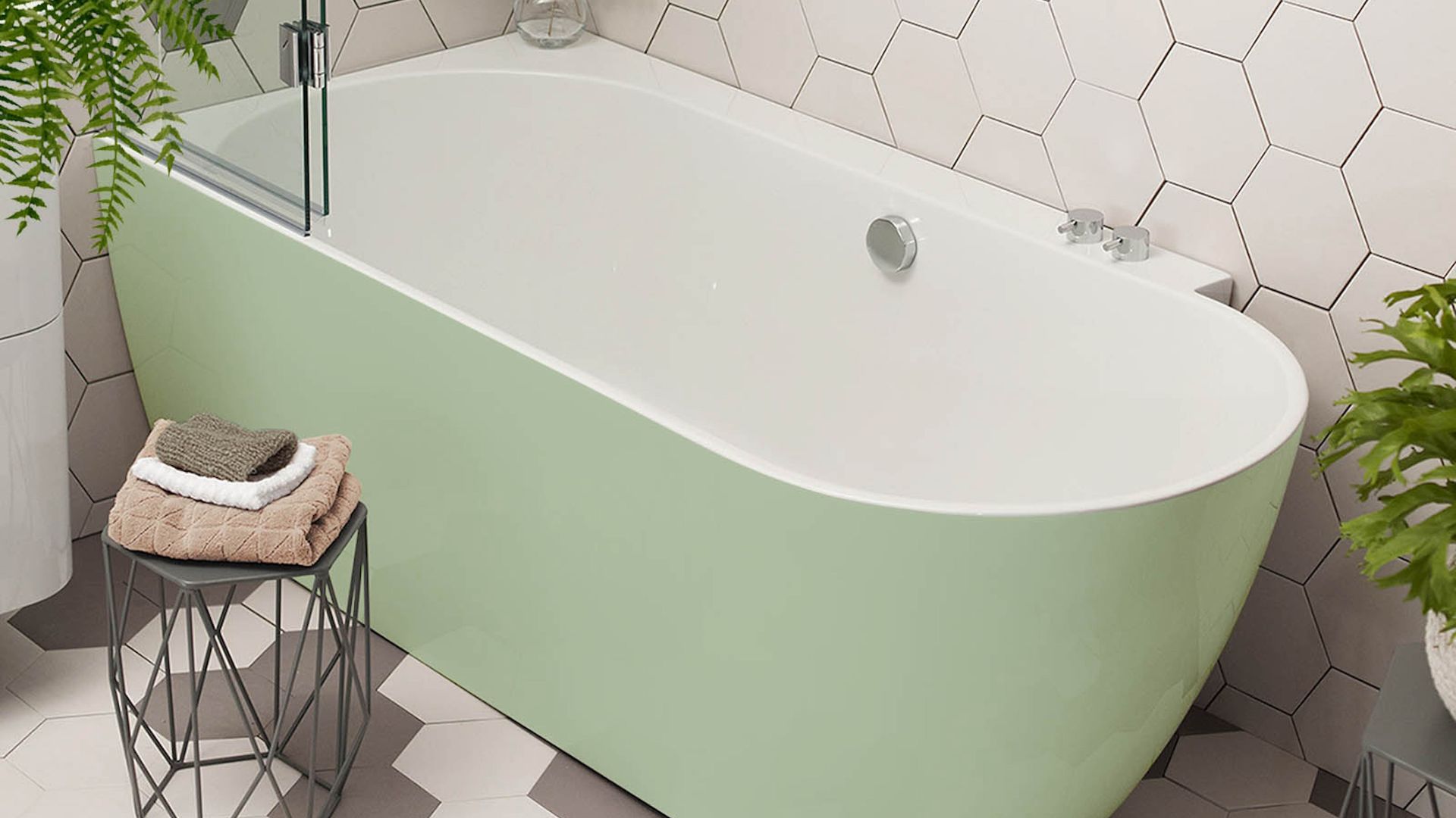 A close up of a bath painted in pistachio green sat against white tiles
