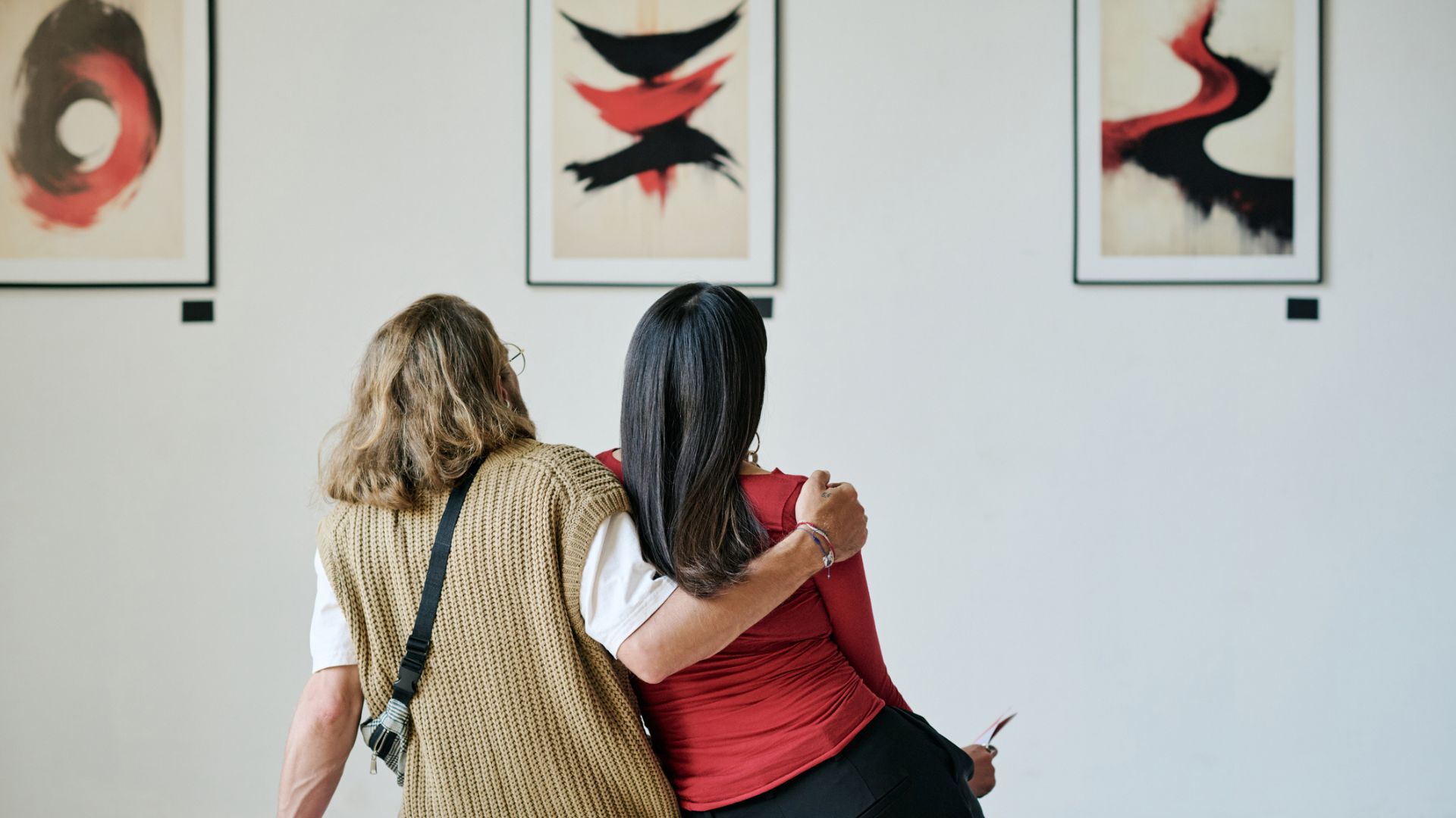 A couple enjoy art in a gallery