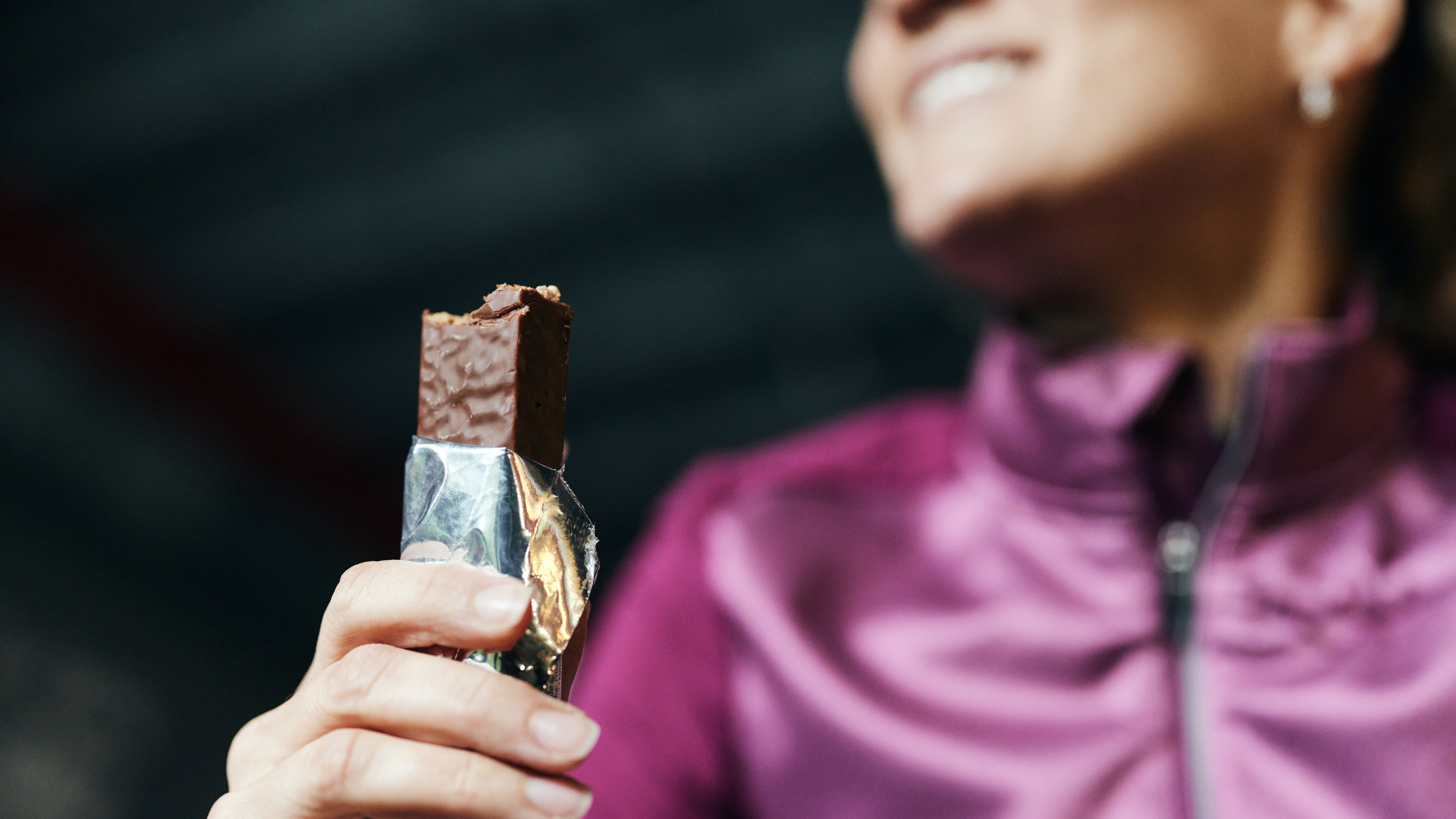 woman eating protein bar