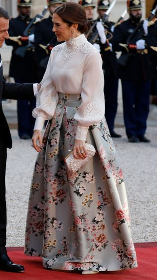 President of France Emmanuel Macron and Queen Mary of Denmark greet each other outside the Elysee presidential palace