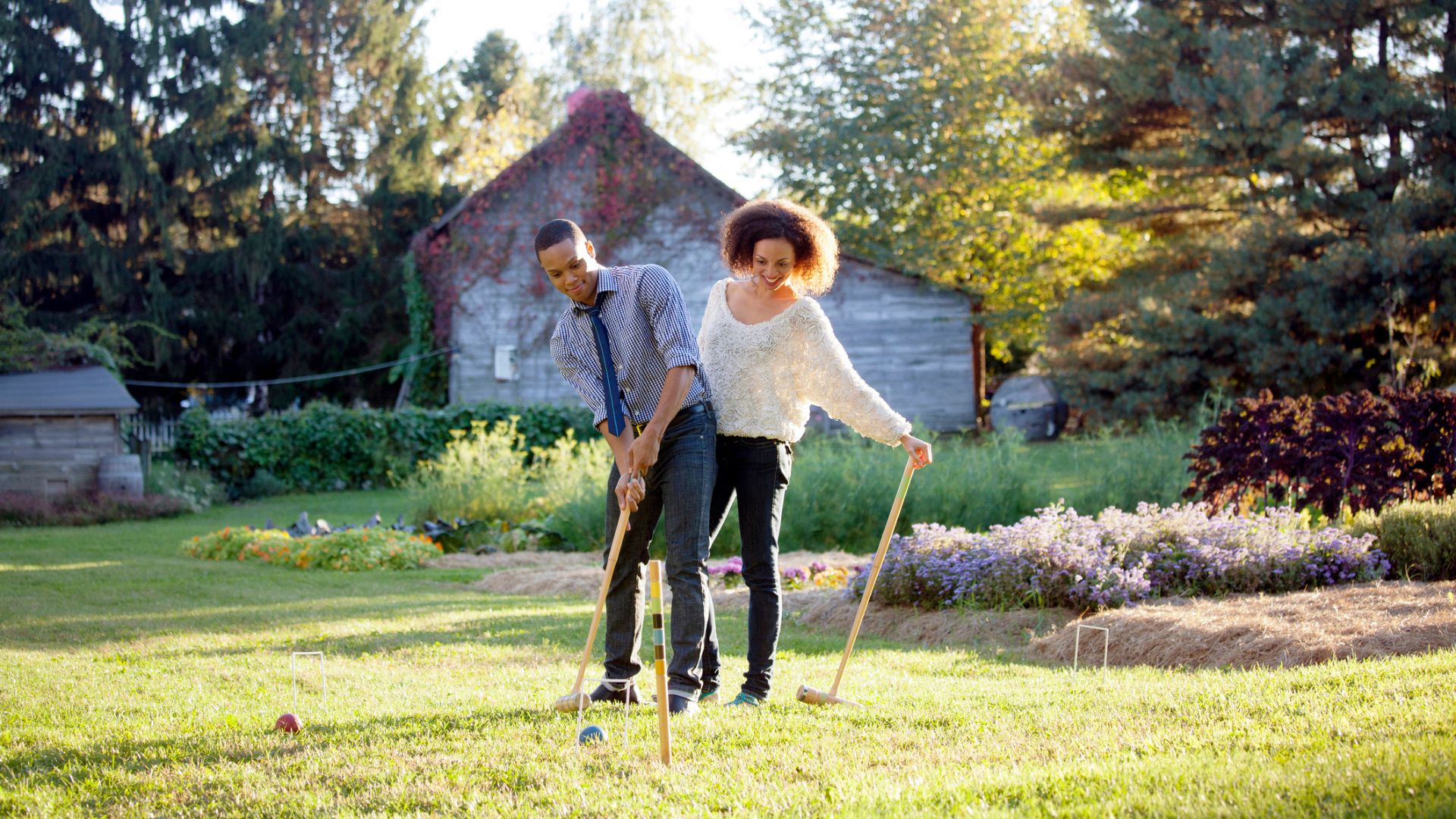 A couple play croquet
