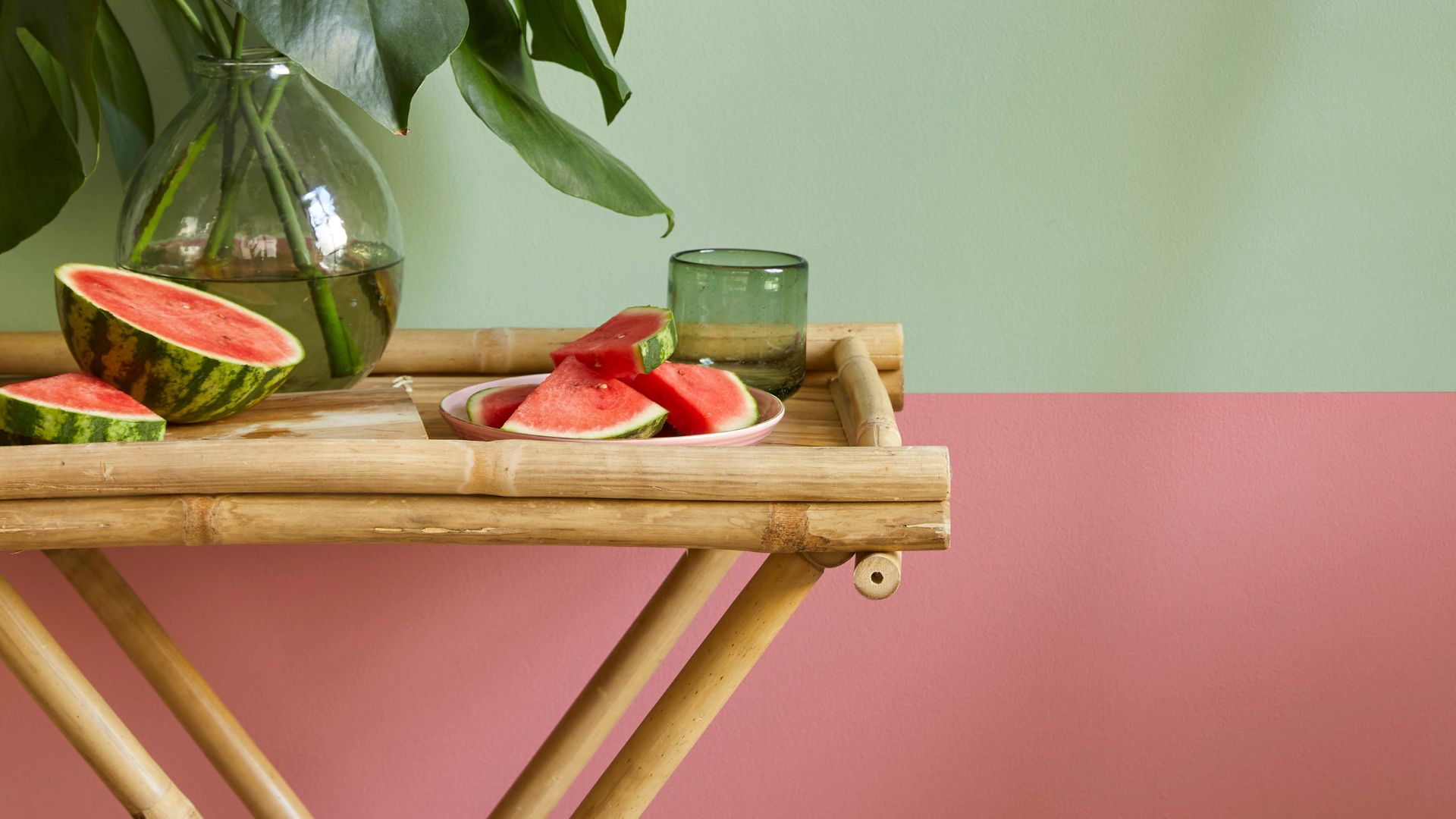 A close up of a wall painted in pistachio green and terracotta