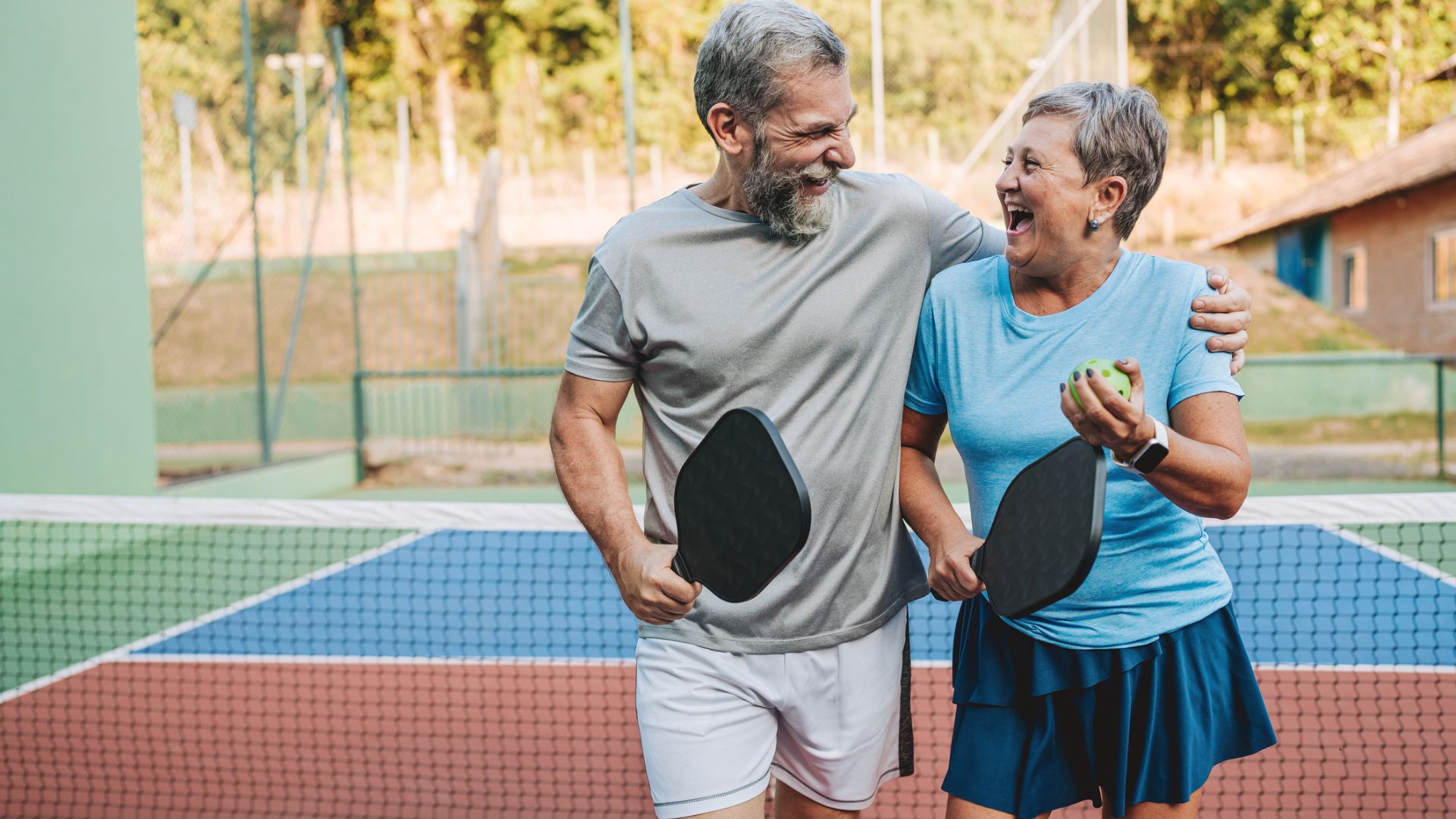A couple laugh after playing pickle ball