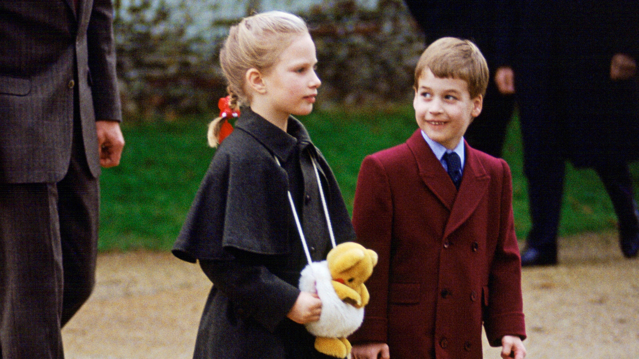 Prince William looks at Zara Tindall as they attend church on Christmas Day 1988