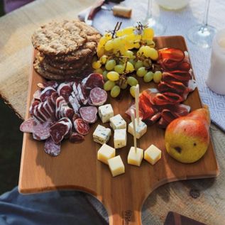 Wooden chopping board used as a platter with food on