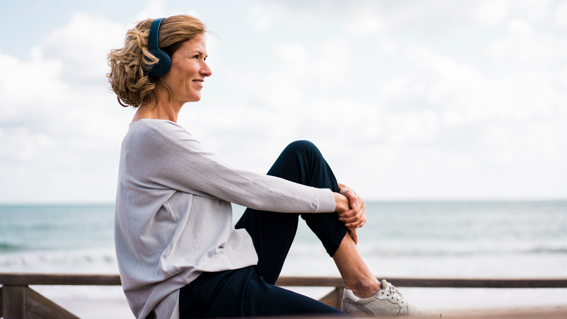 Woman listening to headphones while outdoors