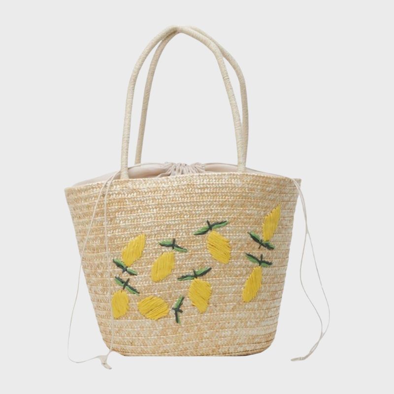 A cutout of a straw bag decorated with lemons