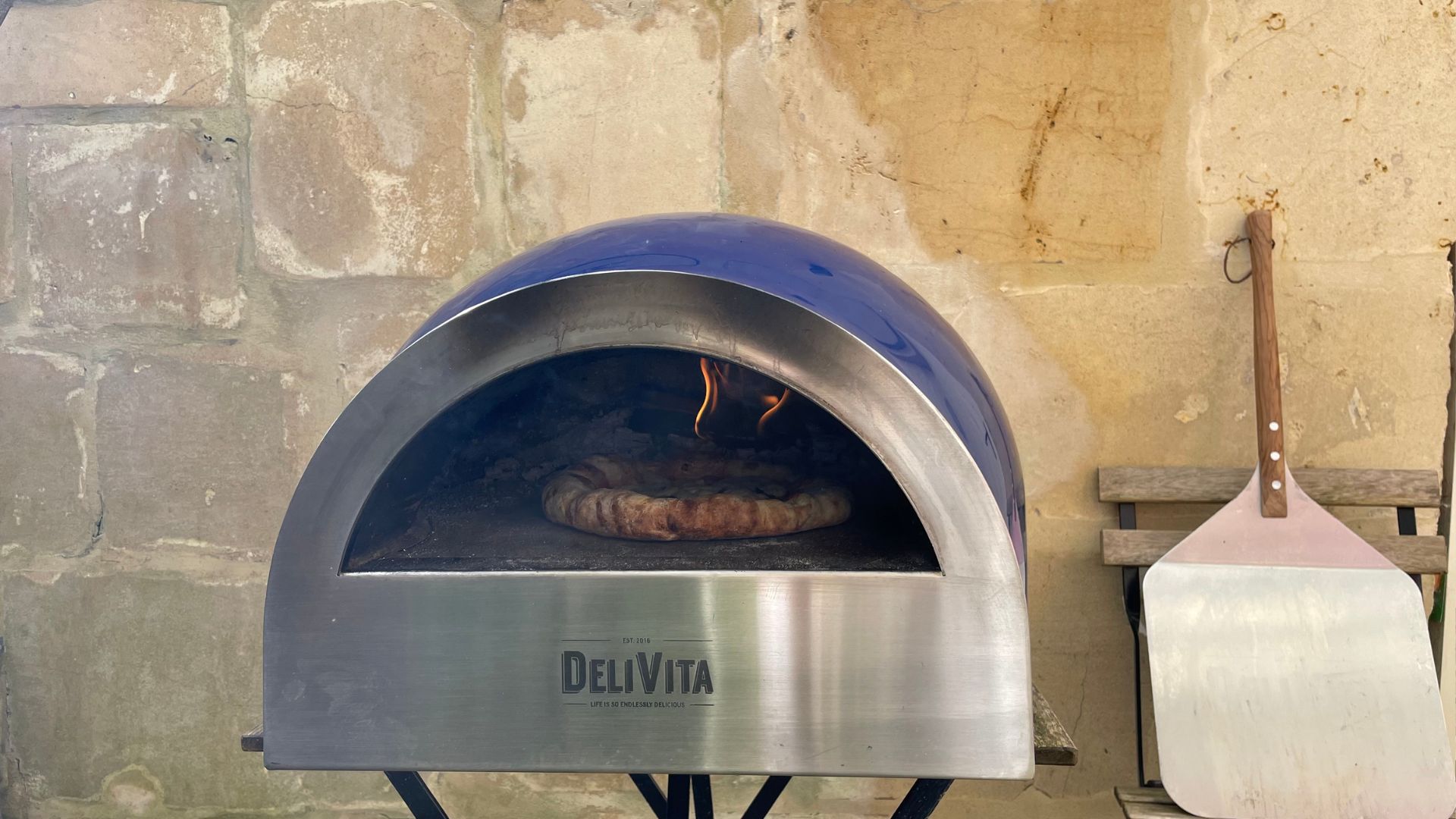 DeliVita Wood Fired Pizza Oven in the courtyard