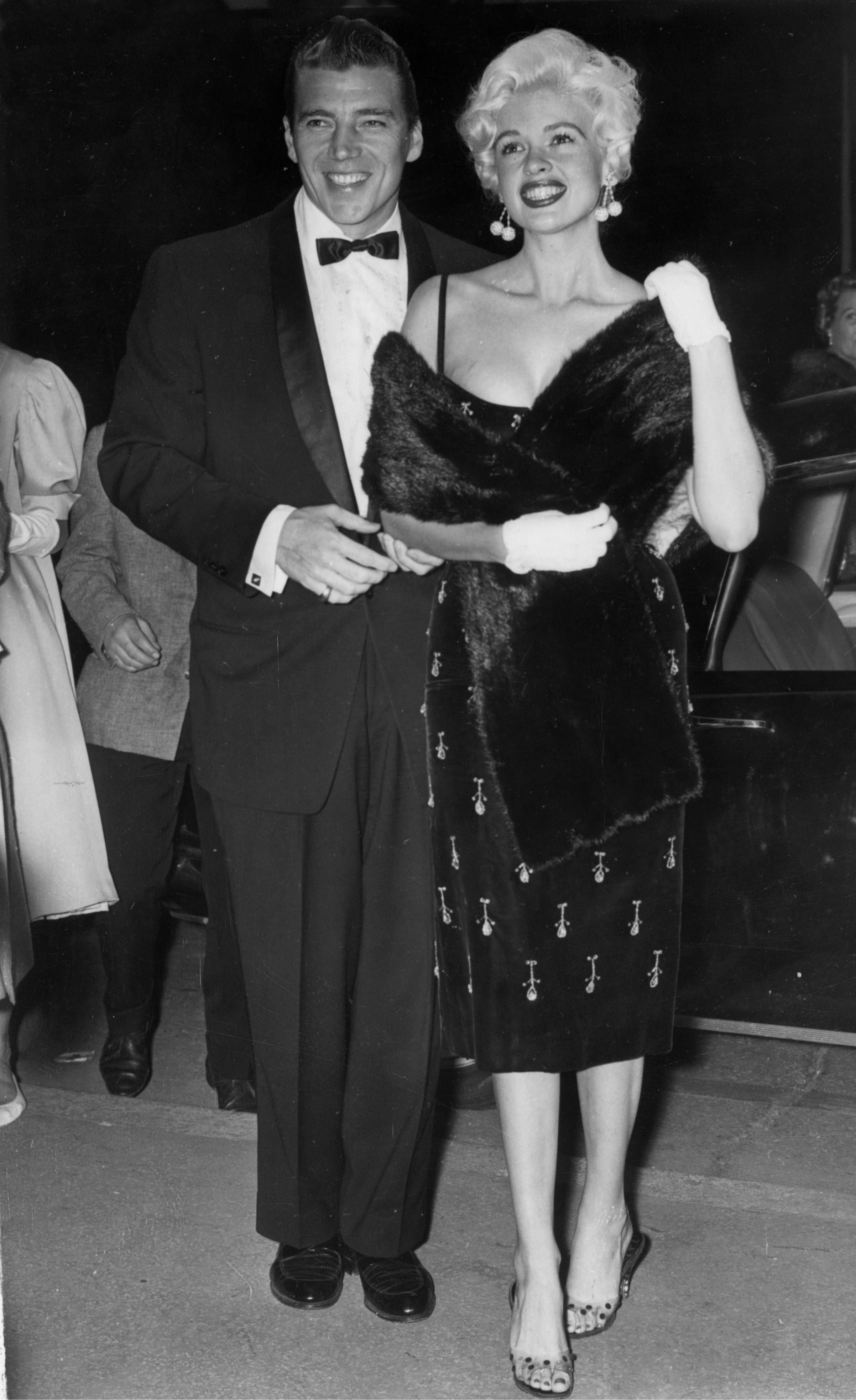 Jayne Mansfield (1933 - 1967) and her husband Mickey Hargitay smile for the cameras at the Cannes film festival.