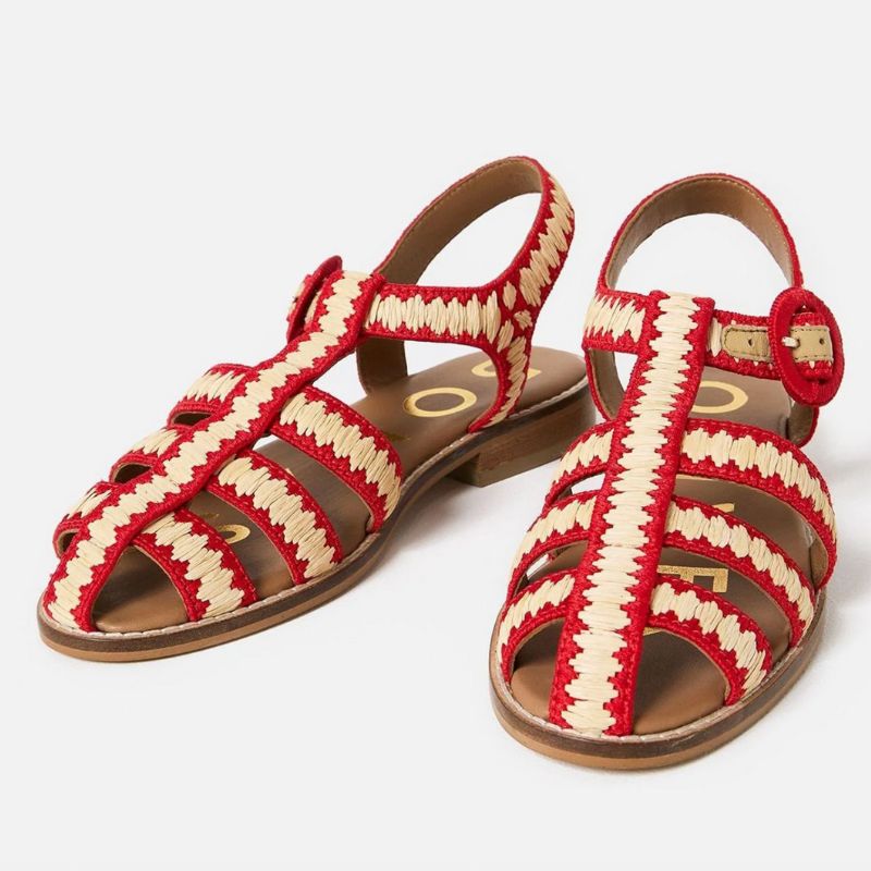 A cutout of cream and red raffia fisherman sandals