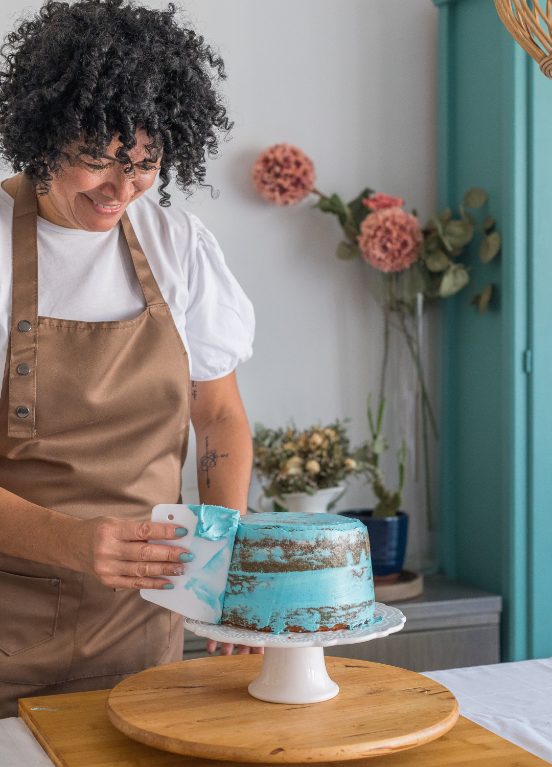 Woman decorating a blue cake