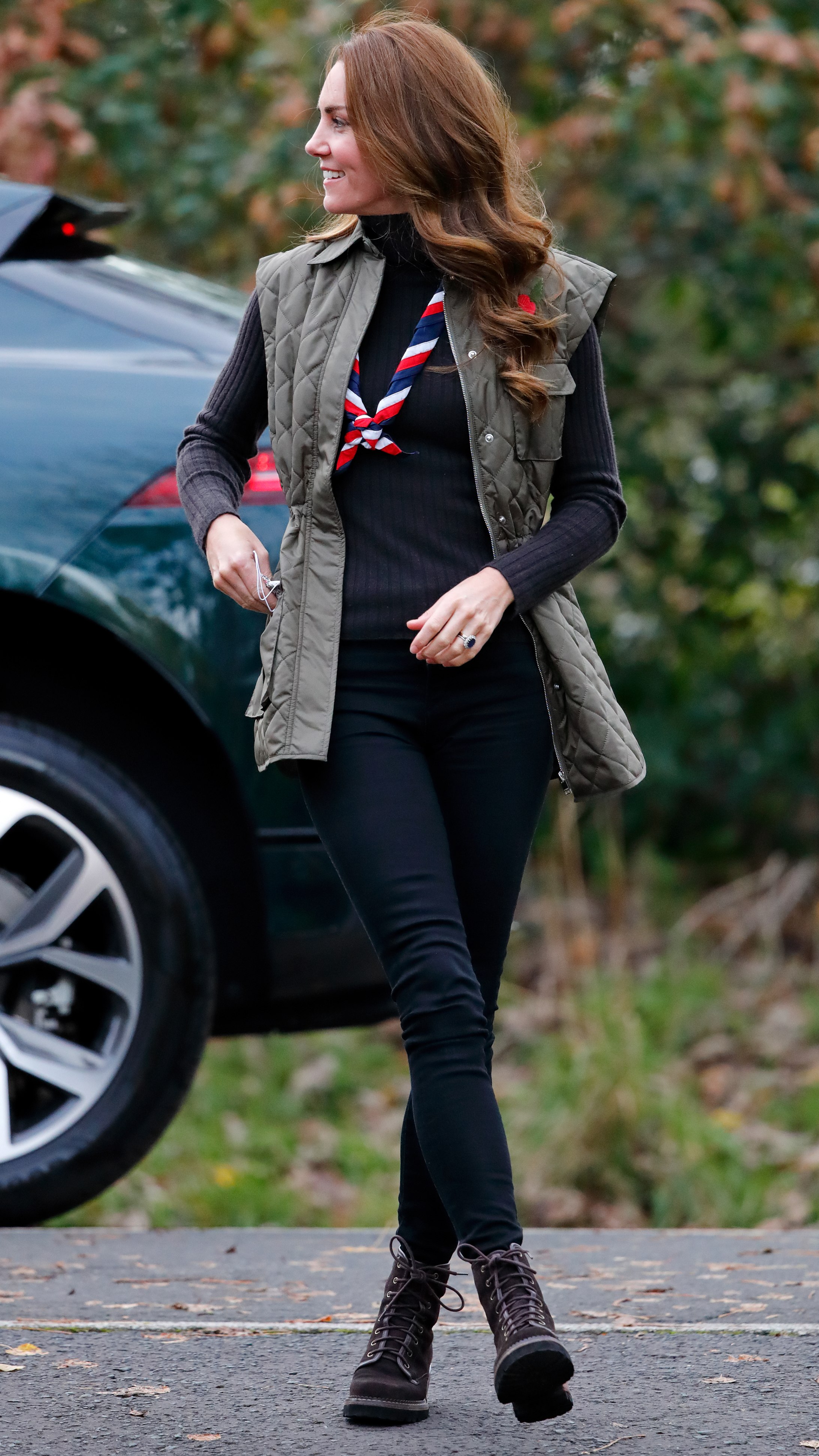 Catherine, Princess of Wales looks off camera as she visits Alexandra Park Sports Hub to meet with Scouts from across the area