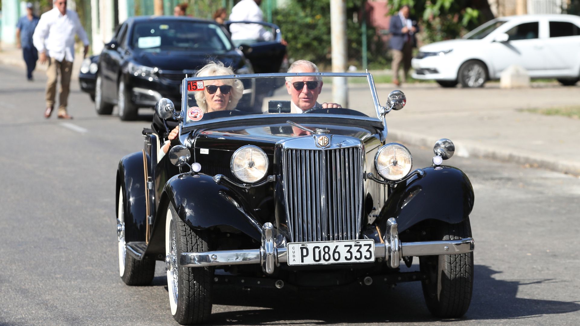 Queen Camilla and King Charles driving in a vintage car in Cuba