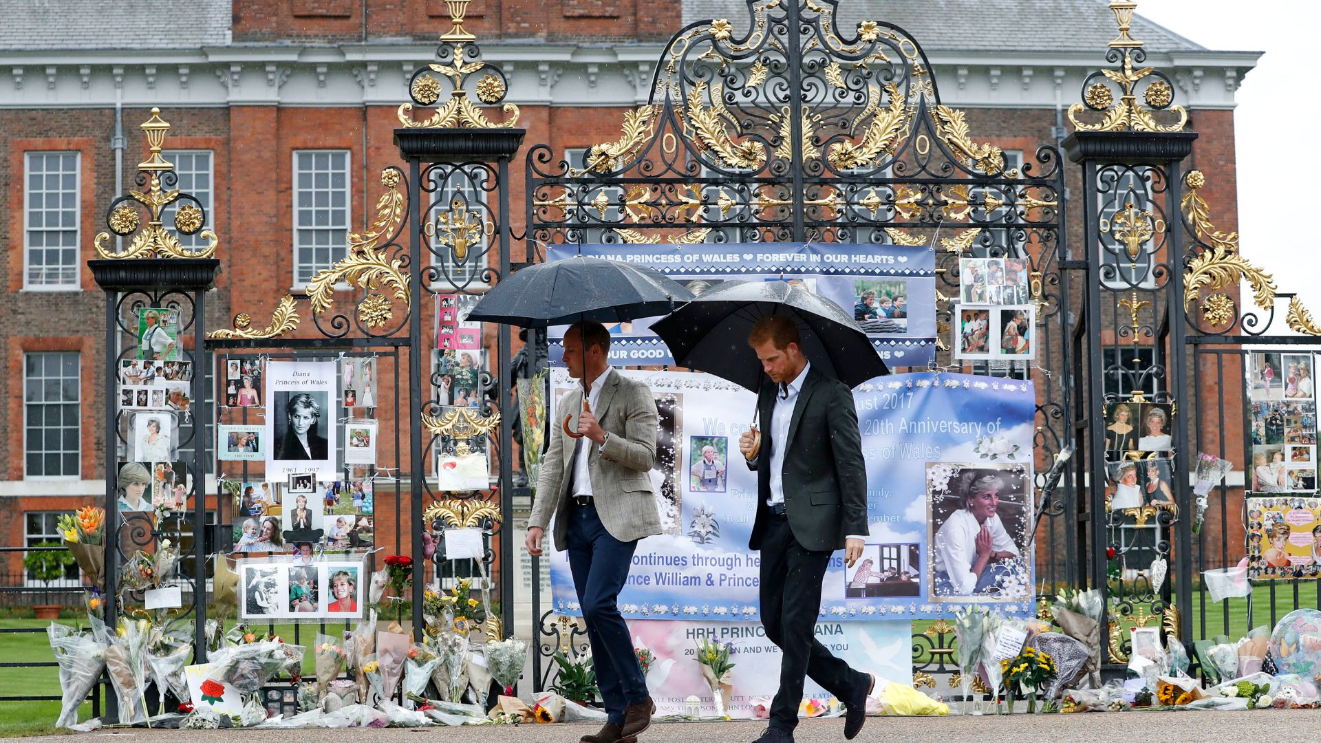 Prince William and Prince Harry look at tributes to Princess Diana outside of Kensington Palace