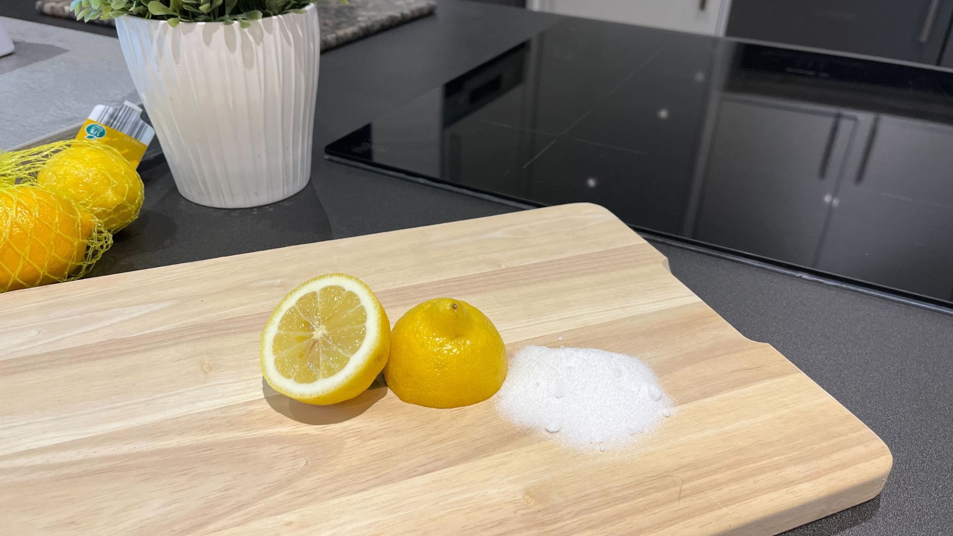 picture of lemon halves and salt on a wooden chopping board