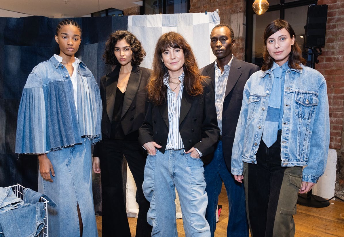 Designer Anna Foster (centre) poses with models at the E.L.V. Denim Presentation during London Fashion Week February 2025