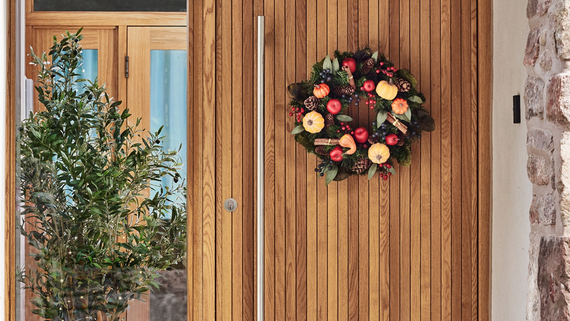 Wooden front door with Lakeland&#039;s autumn Christmas wreath