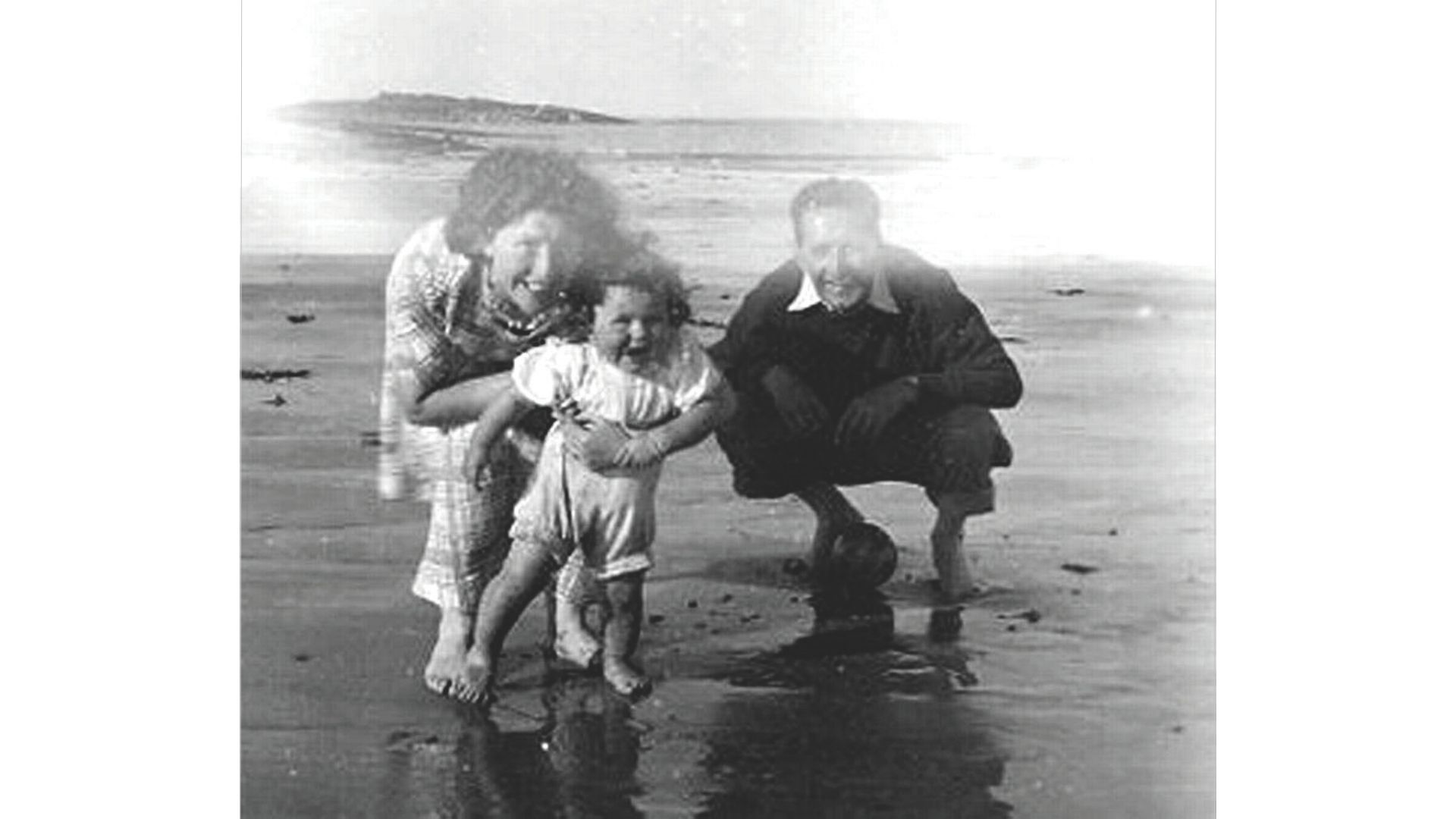 Jenny Lucas aged 18 months at the beach with her adoptive parents