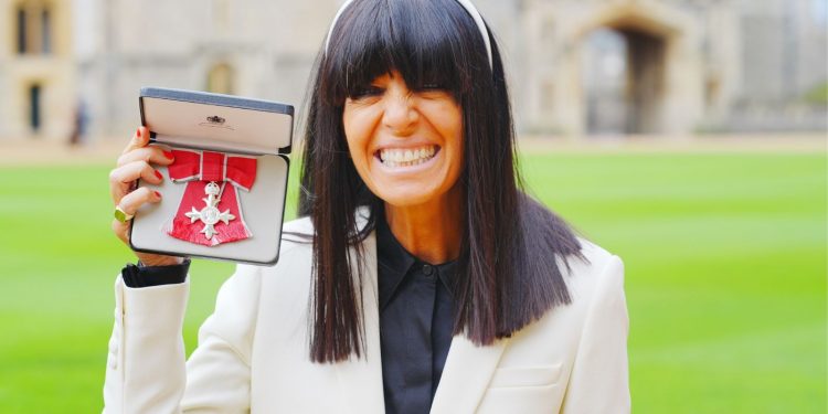 Claudia Winkleman collects her MBE in striking white suit