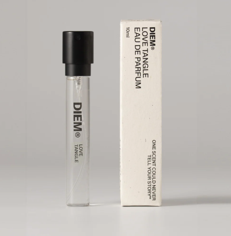 A product shot of the 10ml travel-size DIEM Love Tangle perfume, on a grey background