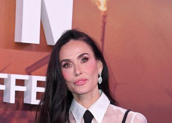 Demi Moore’s layered sheer blouse and strappy black dress combination is a genius styling trick for party season