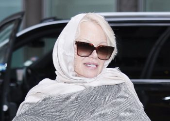 Pamela Anderson’s statement scarf coat is such a chic choice