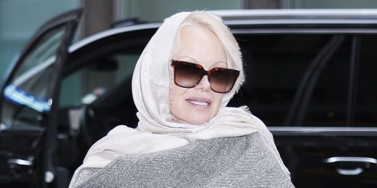 Pamela Anderson’s statement scarf coat is such a chic choice