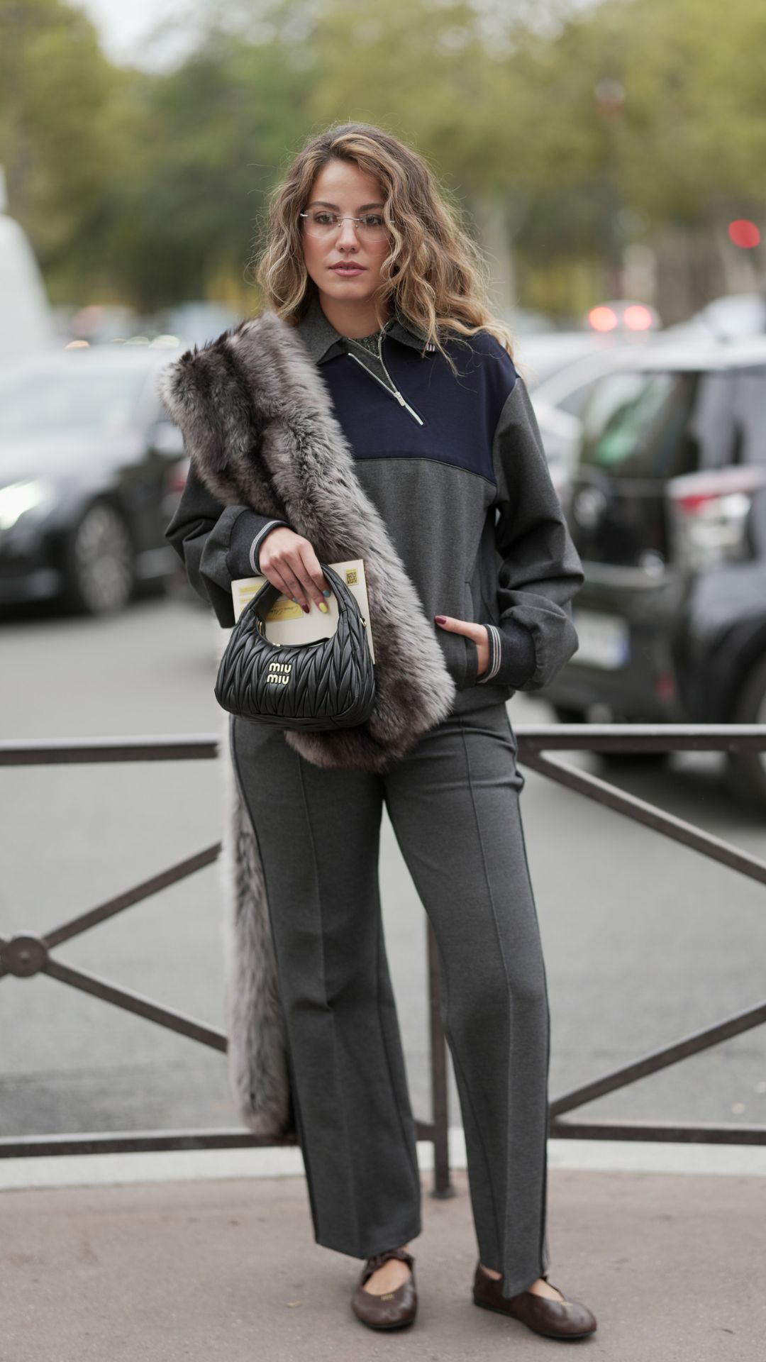 a street style outfit featuring an asymmetric zip neckline