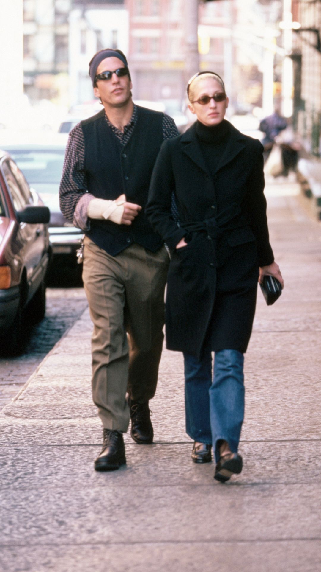 10/18/1997-New York, NY: John F. Kennedy Jr. walks along a New York City street with wife Carolyn Bessette